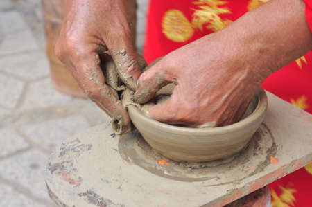 Nha Trang, Vietnam - July 11, 2015: An old woman is performing the ceramic molding techniques at the Po Nagar temple in Nha Trangのeditorial素材