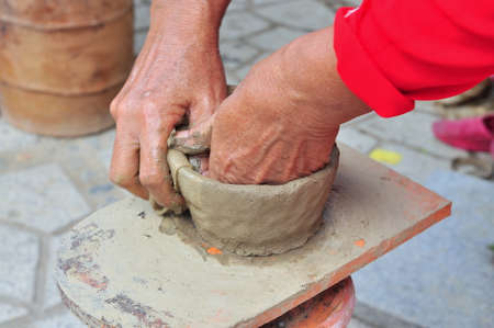 Nha Trang, Vietnam - July 11, 2015: An old woman is performing the ceramic molding techniques at the Po Nagar temple in Nha Trangのeditorial素材