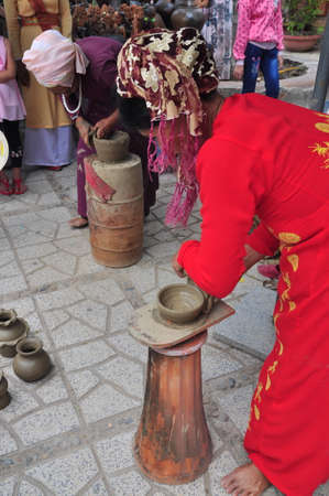 Nha Trang, Vietnam - July 11, 2015: An old woman is performing the ceramic molding techniques at the Po Nagar temple in Nha Trangのeditorial素材