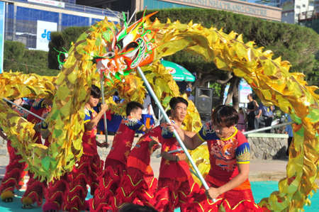 Nha Trang, Vietnam - July 14, 2015: Young boys are performing the lion dance on the beach of Nha Trang cityのeditorial素材