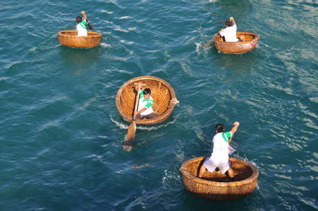 Nha Trang, Vietnam - July 14, 2015: Fishermen are racing by basket boats in the sea of Nha Trang bayのeditorial素材