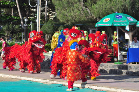 Nha Trang, Vietnam - July 14, 2015: Young boys are performing the lion dance on the beach of Nha Trang cityのeditorial素材