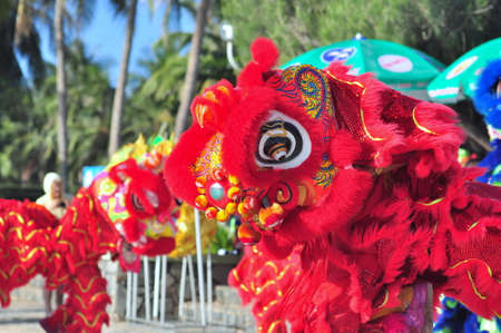 Nha Trang, Vietnam - July 14, 2015: Young boys are performing the lion dance on the beach of Nha Trang cityのeditorial素材