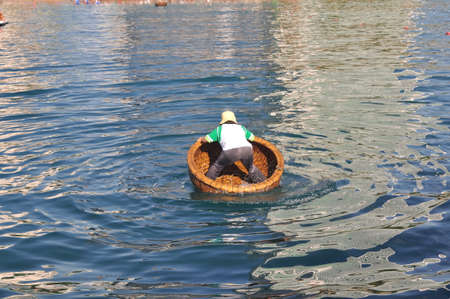 Nha Trang, Vietnam - July 14, 2015: A girl is ready for racing by basket boats in the sea of Nha Trang bayのeditorial素材