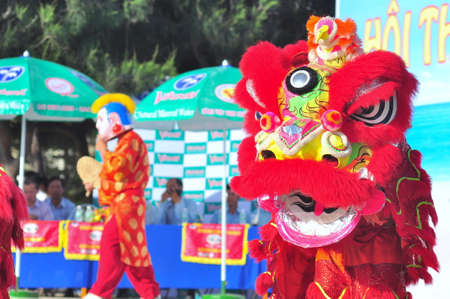 Nha Trang, Vietnam - July 14, 2015: Young boys are performing the lion dance on the beach of Nha Trang cityのeditorial素材