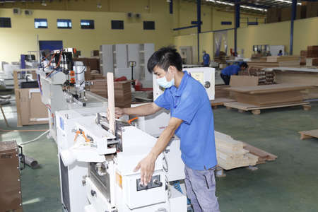 Long An, Vietnam - July 11, 2016: Workers are working in a wood factory for exportingのeditorial素材