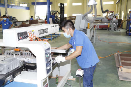Long An, Vietnam - July 11, 2016: Workers are working in a wood factory for exportingのeditorial素材
