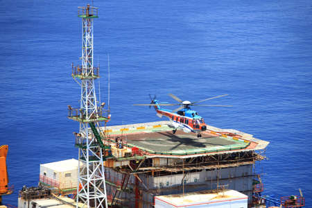 Vung Tau, Vietnam - May 17, 2016: A helicopter is landing on an oil rig in the sea of Vietnamのeditorial素材