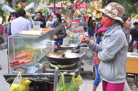 Cam Ranh, Vietnam - February 9, 2016: Street food vendors are serving people in the lunar new year in Vietnamのeditorial素材