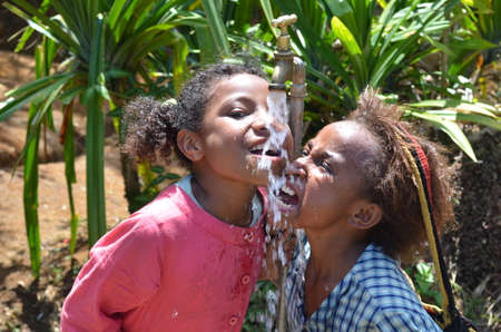 Papua New Guinea - October 25, 2015: Children are happy with water in a remote and difficult place in Papua New Guineaのeditorial素材