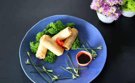 Vietnamese spring rolls on blue dish