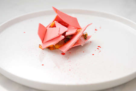 Chocolate truffle with corn on white plateの写真素材