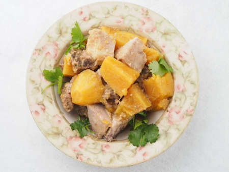 Braised sweet potato on plate in asian restaurantの写真素材