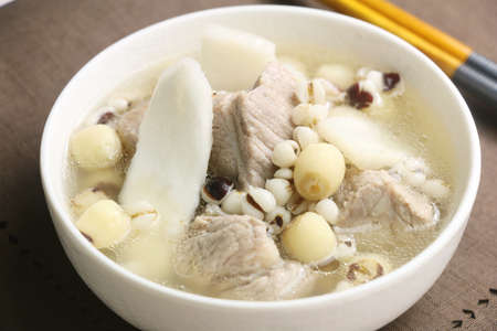 Sishen soup with lotus bean and pork ribs in white bowlの写真素材