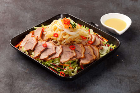 Korean Alssahan style of fried pork feet with mustard sauce on wooden tableの写真素材