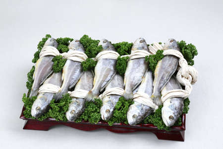 Glory set of gulbi fish on black plate in white backgroundの写真素材