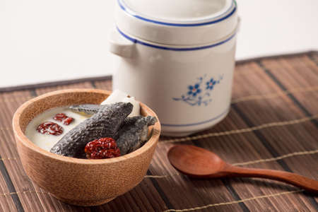 Special Chinese coconut soup with chicken wings on bamboo trayの写真素材