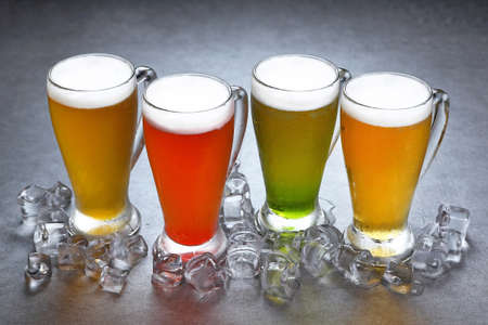 Colorful glass of beer with ice on grey backgroundの写真素材