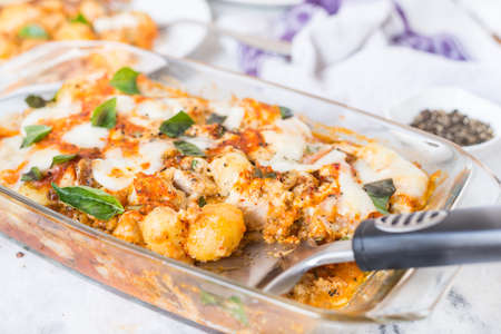 Italian potato and chicken baked recipe on the tableの写真素材