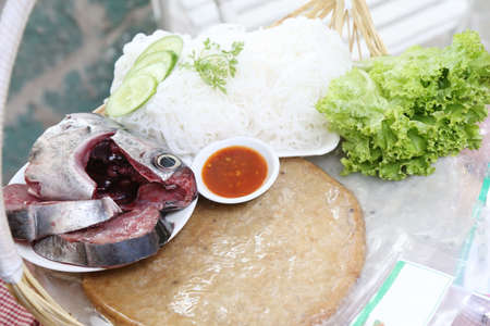 Special Vietnamese rice vermicelli with fresh makerel fish head, fish cake and lettuce or bun caの写真素材