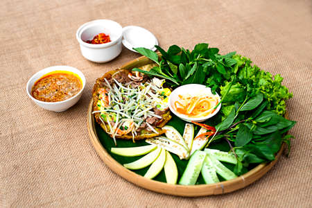 Vietnamese plain rice flan or banh khoai Hue with herbs and special saucesの写真素材
