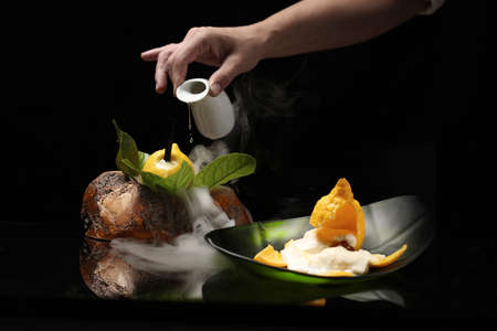 Smoked beef with lemon sauces on black backgroundの写真素材