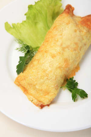 Chicken breast In omletnom pancakes on white plate