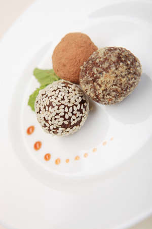 Candy with dried apricots and prunes on white plateの写真素材