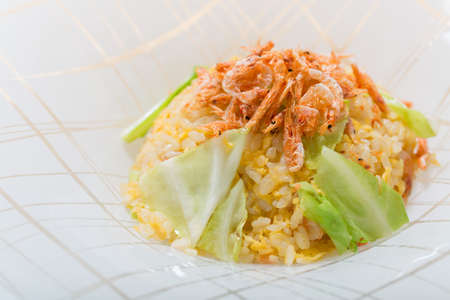 Baby shrimp with fried rice on white plate backgroundの写真素材