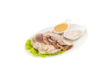 Bolied pork meart with lettuce and sauces on white plateの写真素材