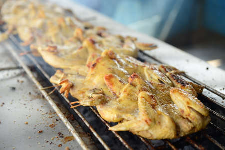 Roasting the whole chicken on the grill in asian restaurantの写真素材