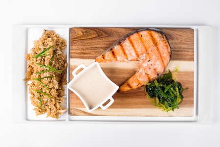 Salmon with Thai rice and sauce on white backgroundの写真素材