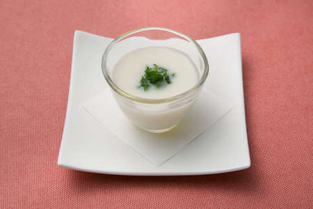 Rice soup in glass on white plate in restaurantの写真素材