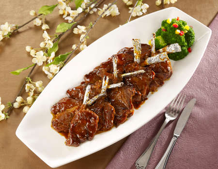 Wine fried lamb cutlets on white plate in restaurantの写真素材