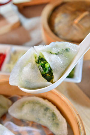 Crystal chives dumpling dishes sinks on white spoonの写真素材