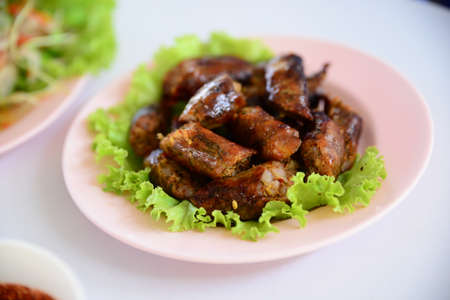 Chicken popper rolls with lettuce on white plate in restuarntの写真素材