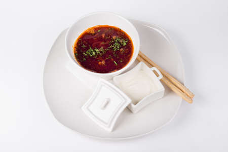 Siberian soup on smoked bones on white plateの写真素材