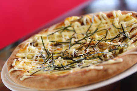 Teriyaki Chikinpiza or Japanese chicken Pizza on white dishの写真素材
