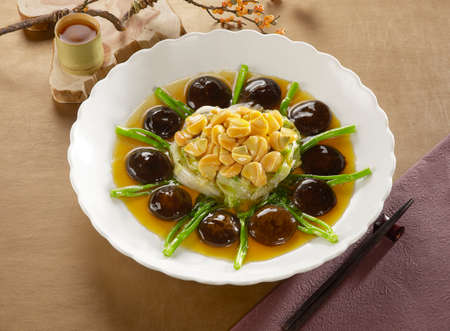 Braised Abalone with mushroom on white plate in restaurantの写真素材