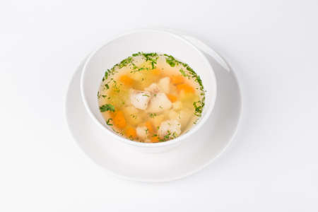 Soup of the Lake walleye with fish and carrot in white bowlの写真素材