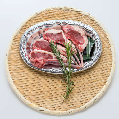 Fresh red beef cow ribs with rosemarry on bamboo trayの写真素材