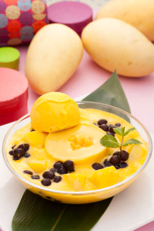 Full fledged mango plans and tea beauty parfait desserts on green leafの写真素材