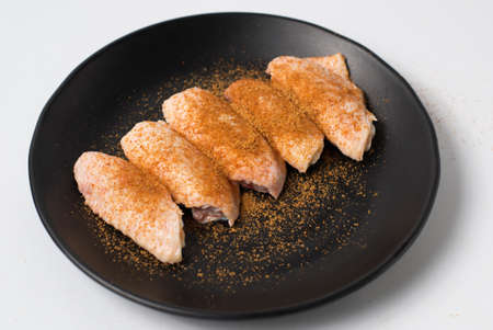 Chicken thigh wings seasoned with spicesの写真素材