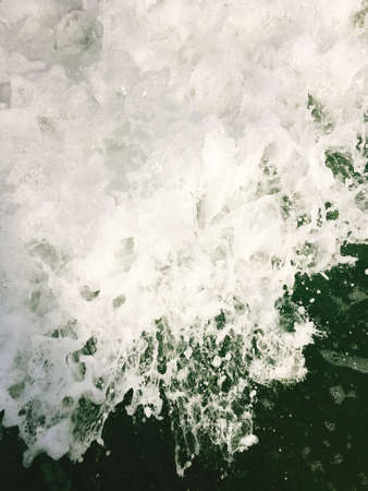 Sea waves reaching lapping to shoreの写真素材