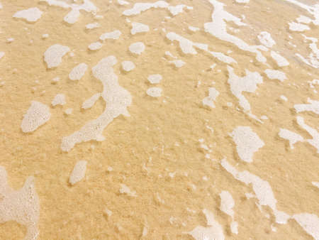 Sea waves reaching lapping to shoreの写真素材
