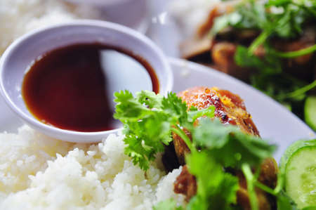 Vietnamese broken rice or com tam with fried chicken legs, pork and herbsの写真素材