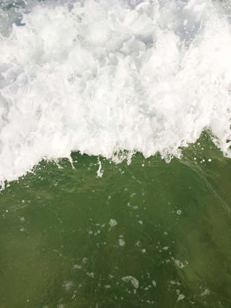 Sea waves reaching lapping to shoreの写真素材