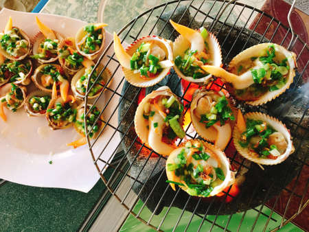 Delicious shell or clams mussels on hot fire coal grillの写真素材