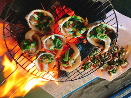 Delicious shell or clams mussels on hot fire coal grillの写真素材