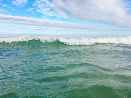 Sea waves reaching lapping to shoreの写真素材